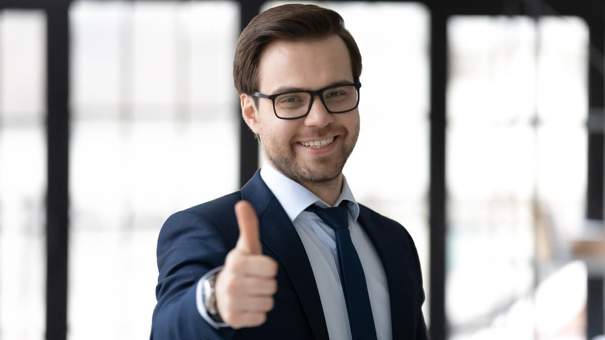 Portrait Of Smiling Young Professional Caucasian Male Giving Thumbs Up