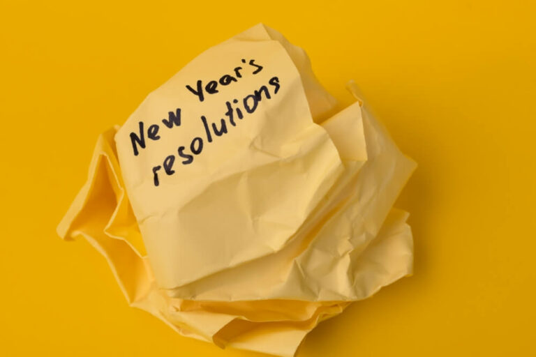 crumpled up yellow paper of new year’s resolutions