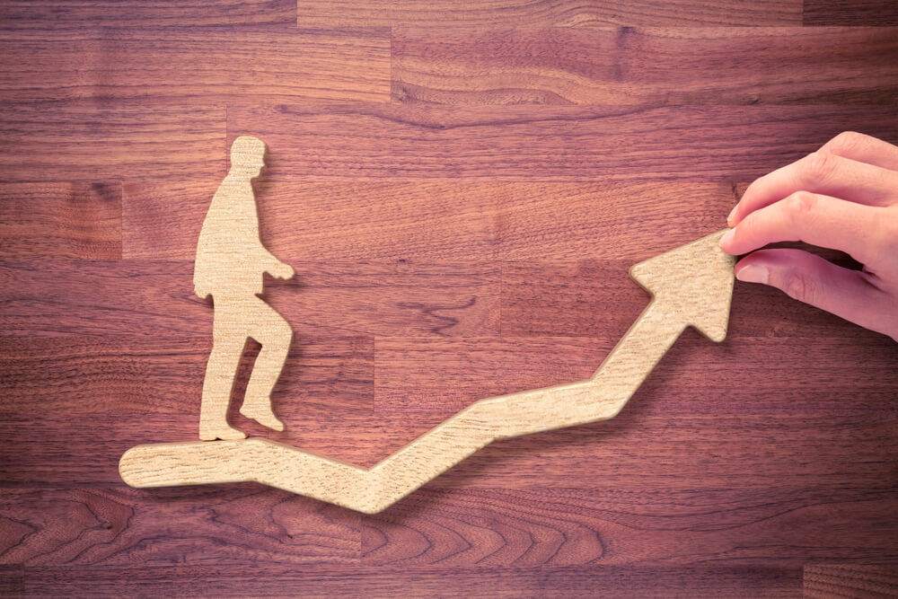 wooden figure walking on upward path, coaching concept