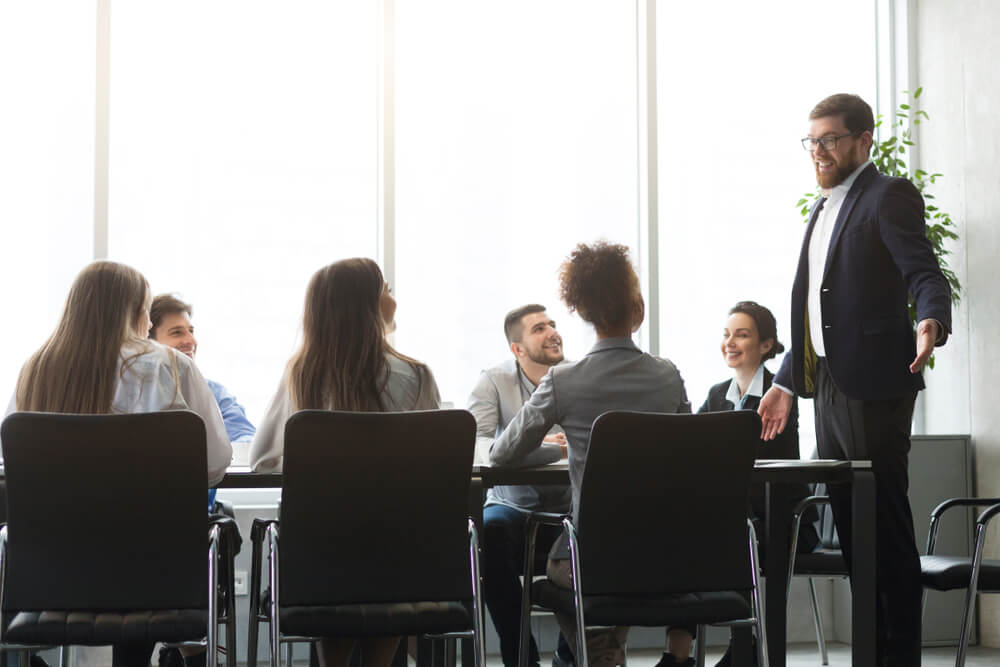 male coach talking to groups of managers